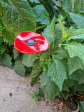 Fused glass poppy bee feeder.