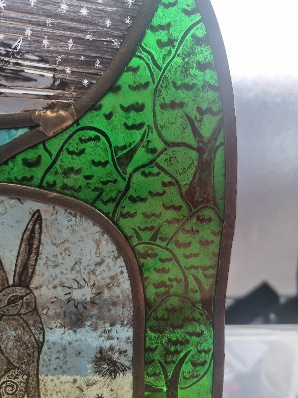 Stunning hare and moon stained glass panel.