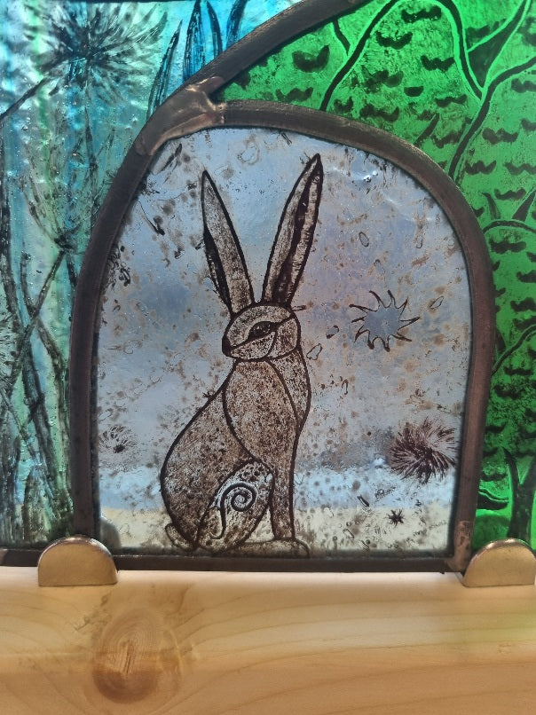 Stunning hare and moon stained glass panel.