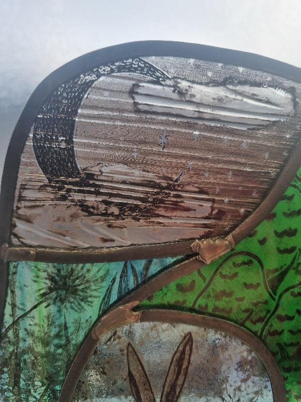 Stunning hare and moon stained glass panel.